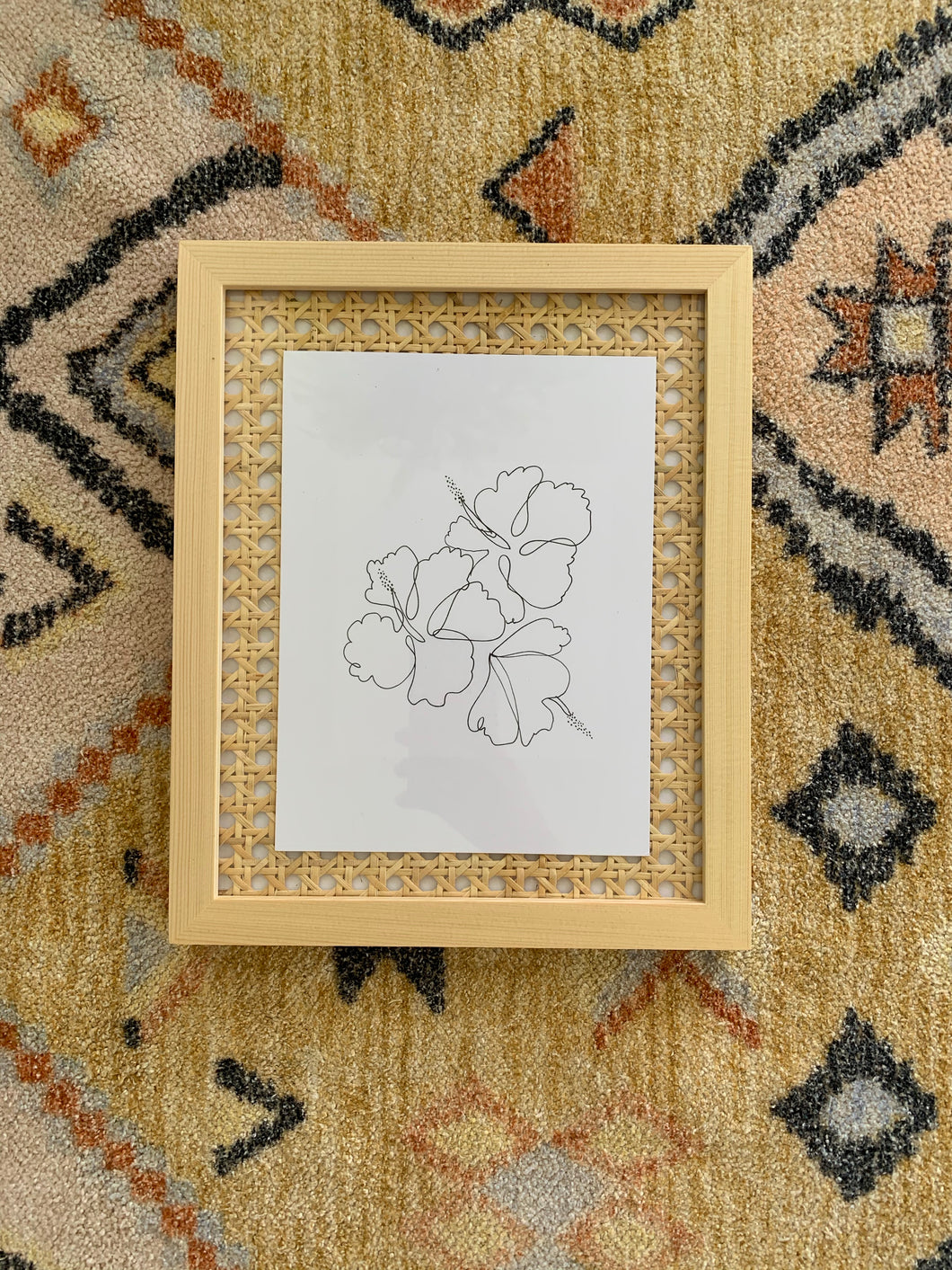 Line hibiscus art print with cane background frame.